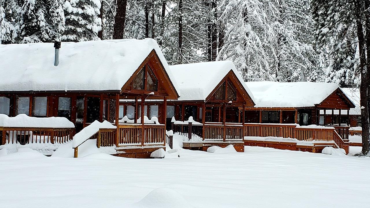 Three snow-covered cabins at Cold Springs Resort in Camp Sherman, OR