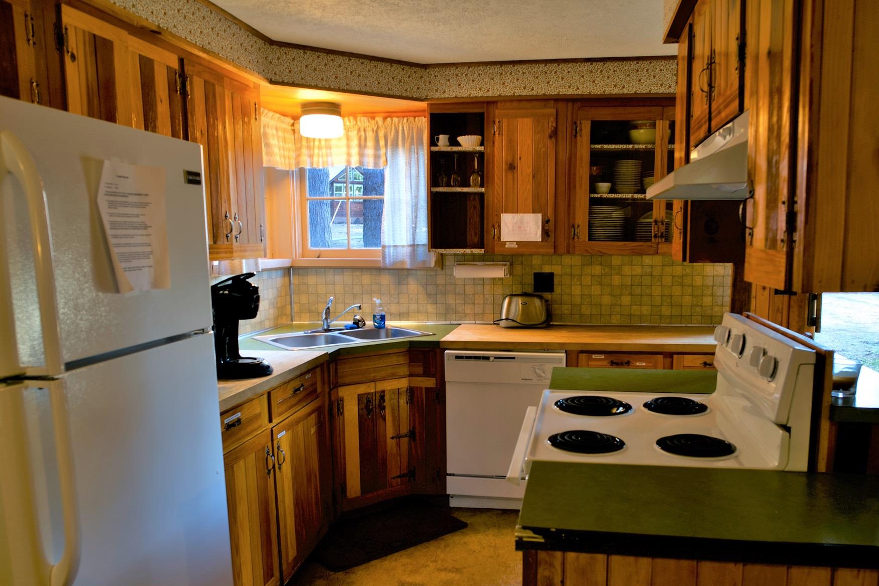 Cook up a delicious family dinner in the kitchen of Haberman Cabin at Cold Springs Resort & RV Park in Camp Sherman, Oregon