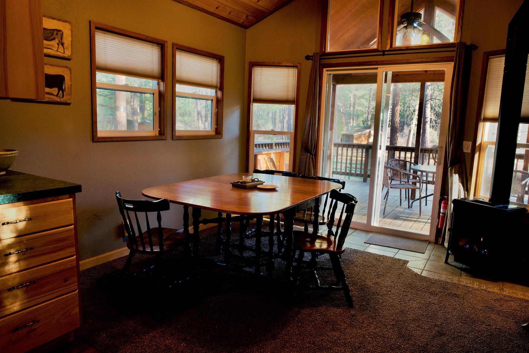 Serve up a delicious family dinner in the spacious dining area of Alder Cabin at Cold Springs Resort & RV Park in Camp Sherman, Oregon