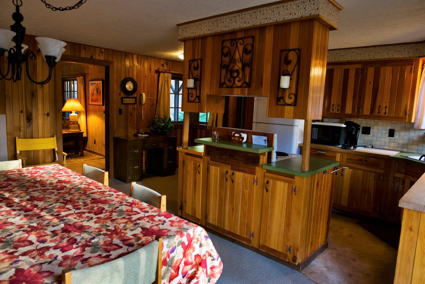 Serve up a delicious family dinner in the spacious dining and kitchen area of Haberman Cabin at Cold Springs Resort & RV Park in Camp Sherman, Oregon