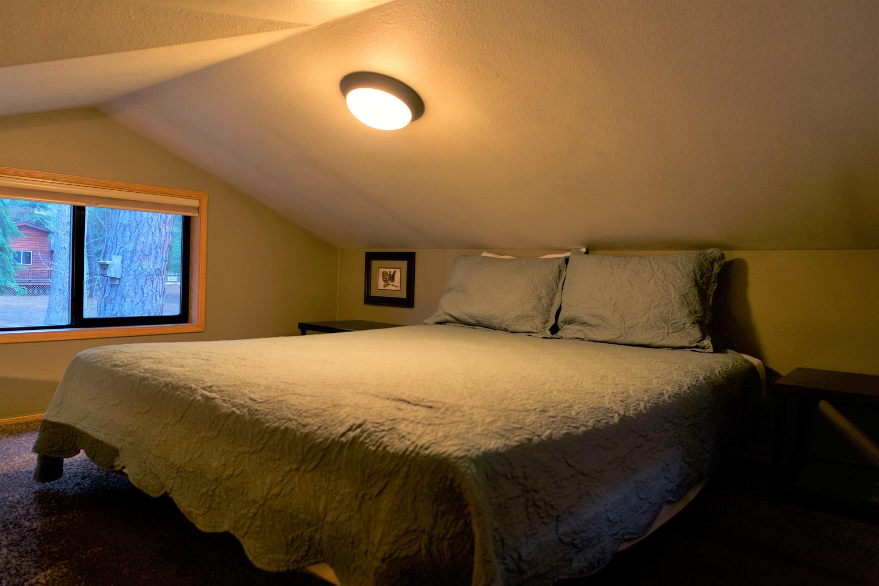 Get your best night sleep in the cozy queen bed in the loft of Spruce Cabin at Cold Springs Resort & RV Park in Camp Sherman, Oregon