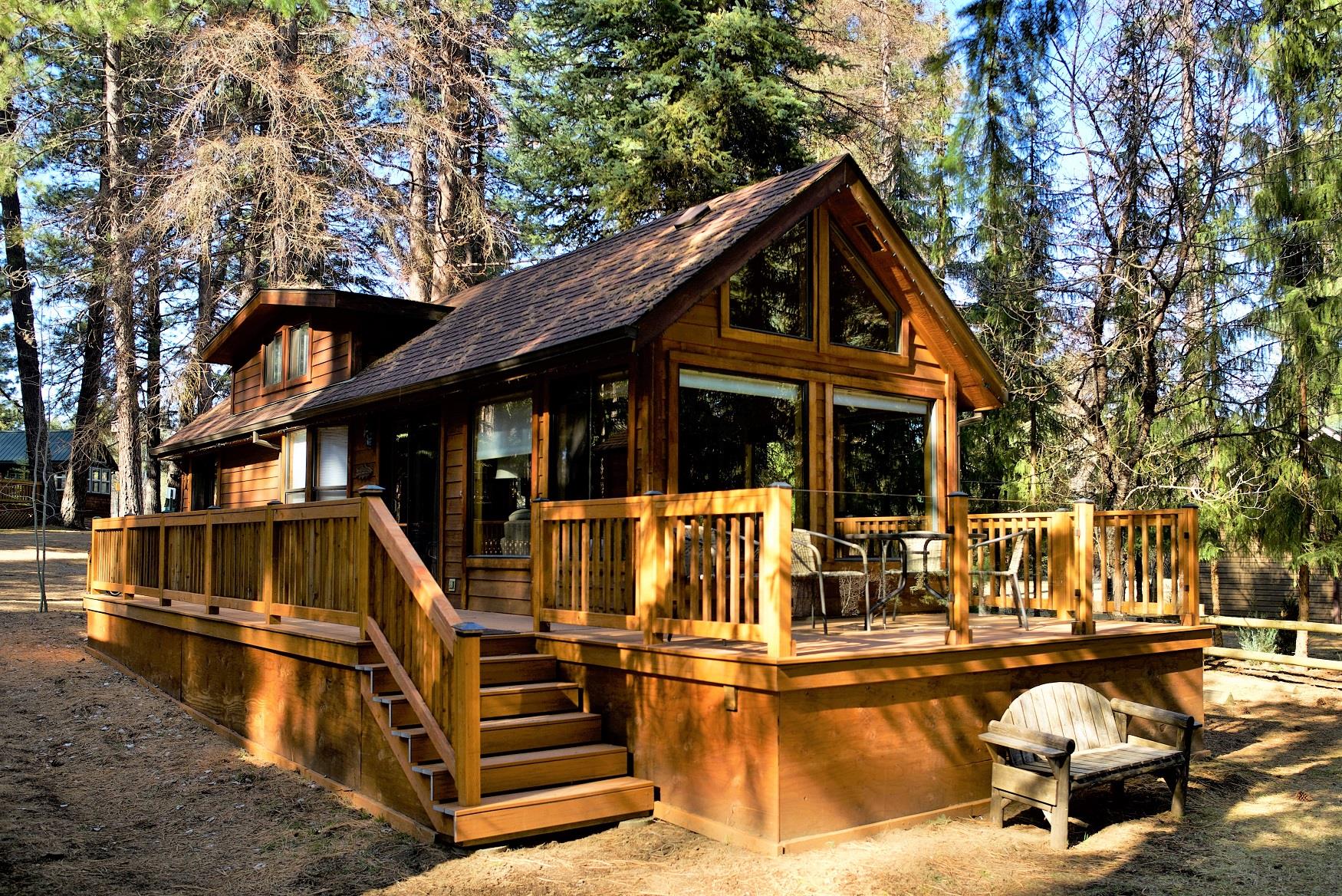 The spacious front deck of Riverview Cabin, at Cold Springs Resort, looks out directly onto the pristine Metolius River, in Camp Sherman, Oregon