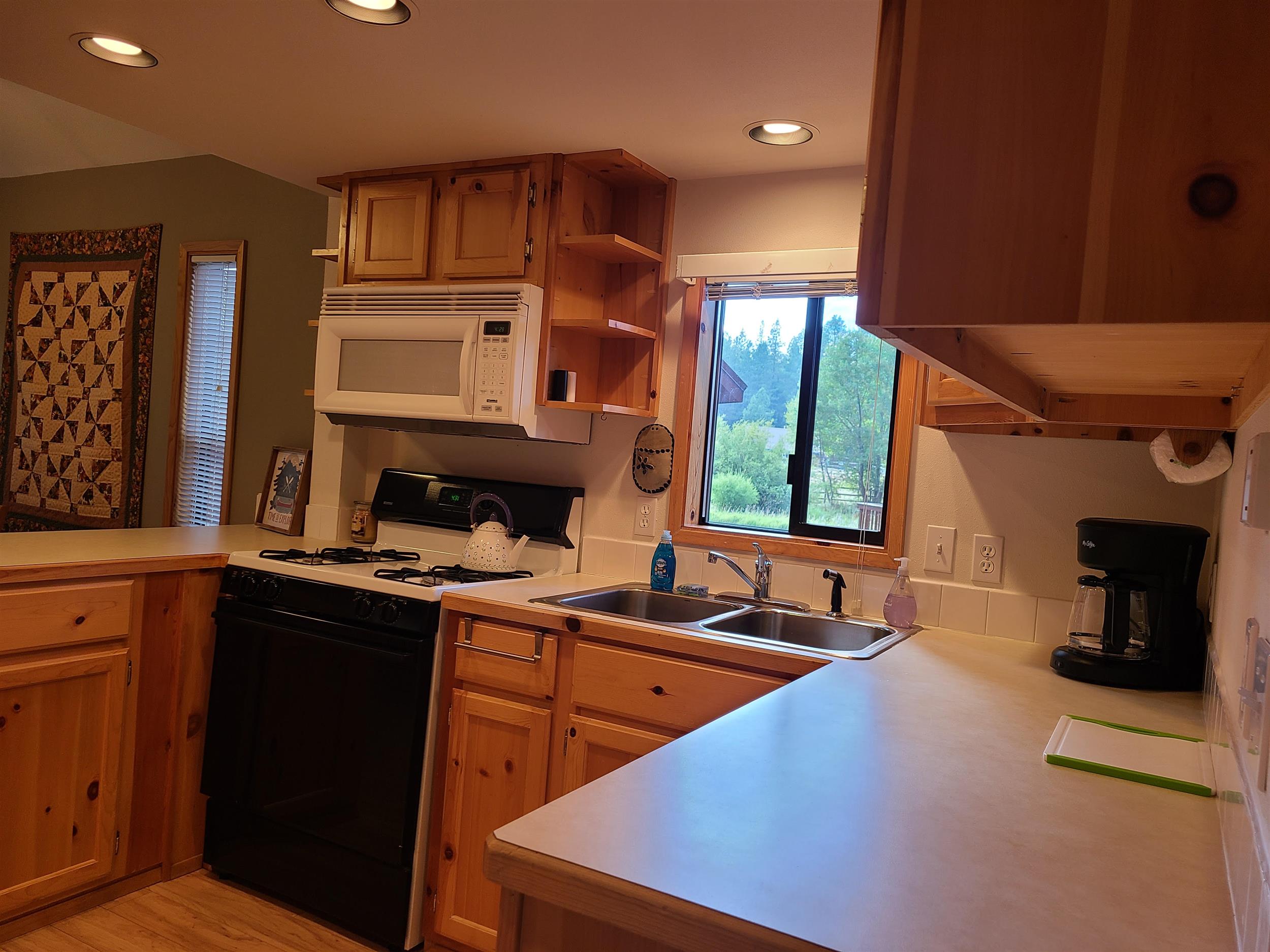 Cook up a delicious family dinner in the kitchen of Cottonwood Cabin at Cold Springs Resort & RV Park in Camp Sherman, Oregon