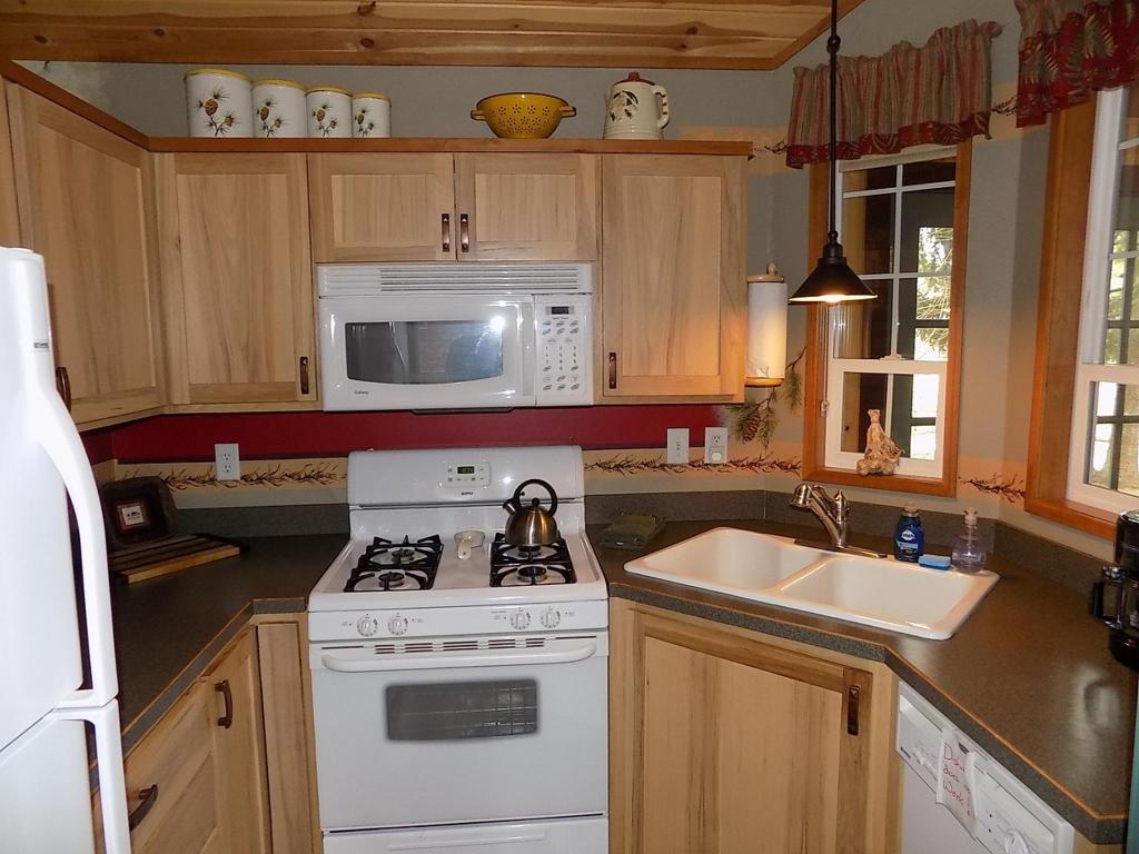Cook up a delicious family dinner in the kitchen of Pinecone Cabin at Cold Springs Resort & RV Park in Camp Sherman, Oregon