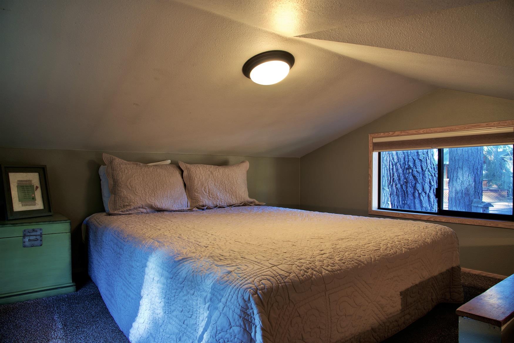 Get your best night sleep in the cozy queen bed in the loft of Aspen Cabin at Cold Springs Resort & RV Park in Camp Sherman, Oregon