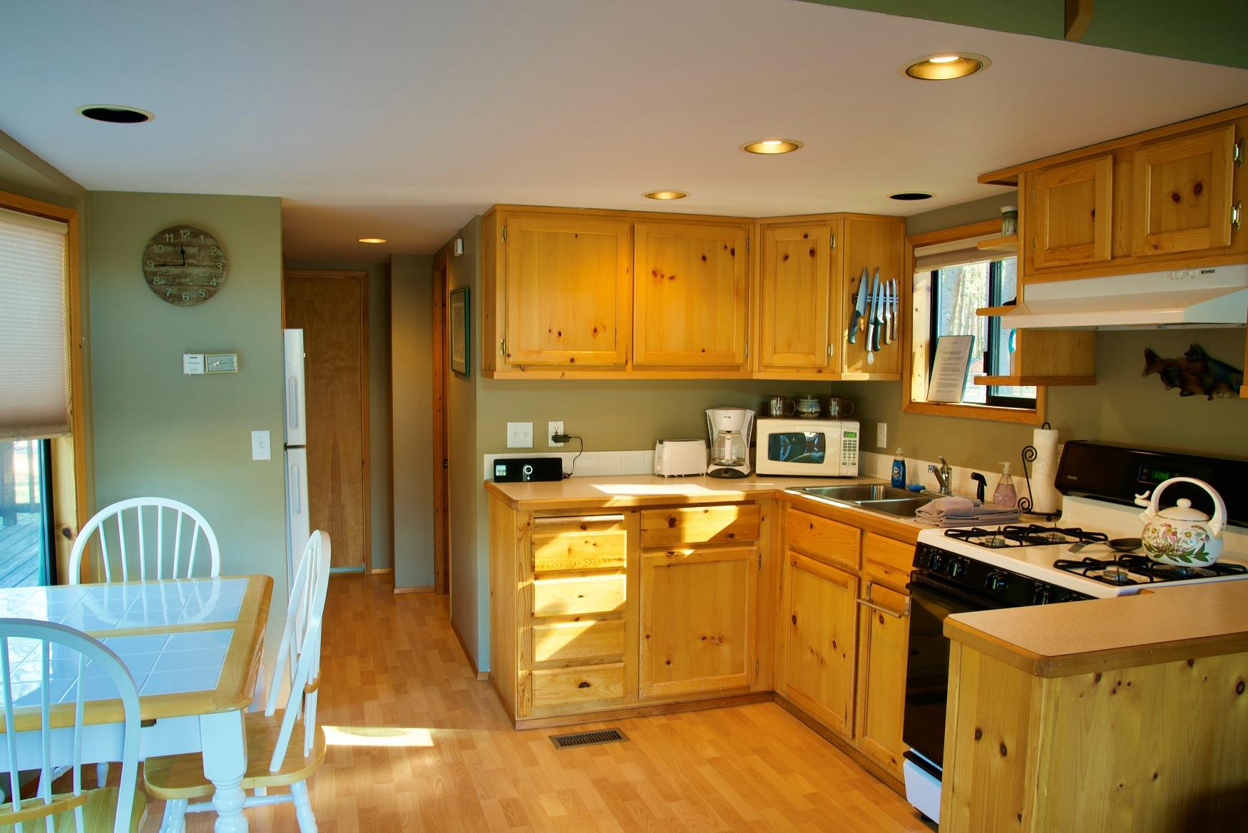 Cook up a delicious family dinner in the kitchen of Maple Cabin at Cold Springs Resort & RV Park in Camp Sherman, Oregon