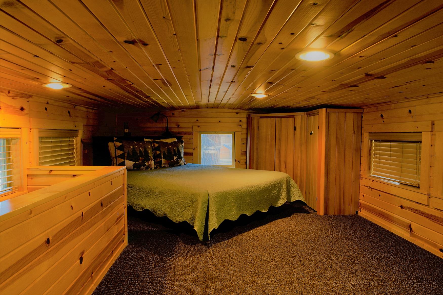 Get your best night sleep in the cozy queen bed in the loft of Ponderosa Cabin at Cold Springs Resort & RV Park in Camp Sherman, Oregon