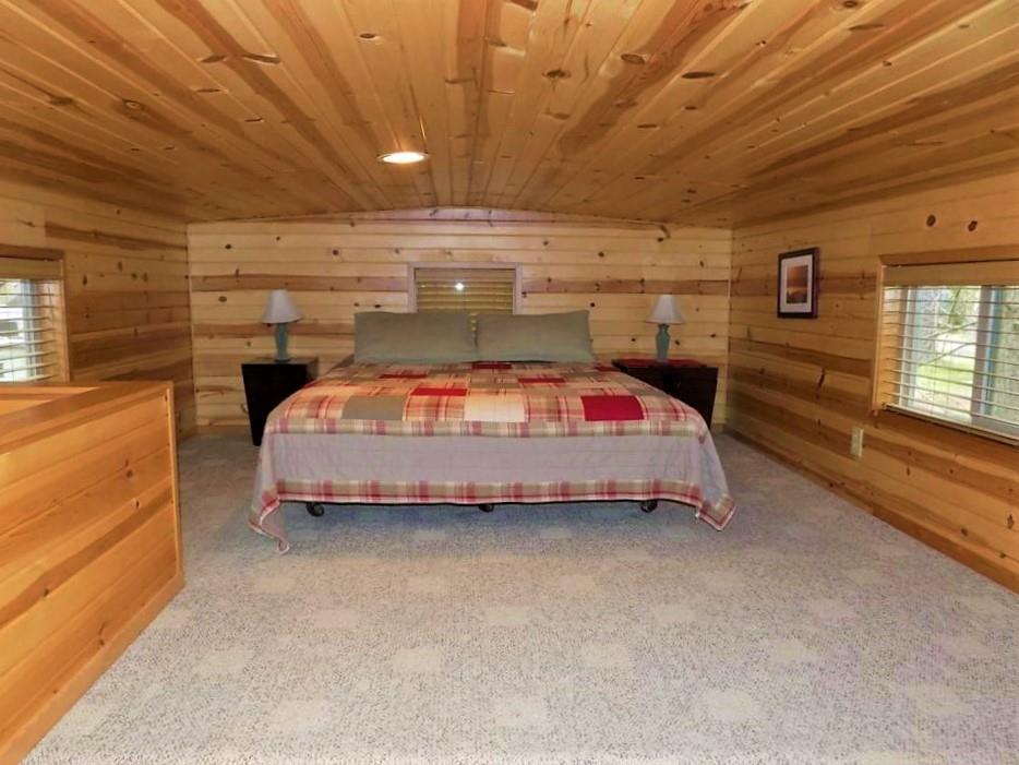 Get your best night sleep in the cozy queen bed in the loft of Larch Cabin at Cold Springs Resort & RV Park in Camp Sherman, Oregon