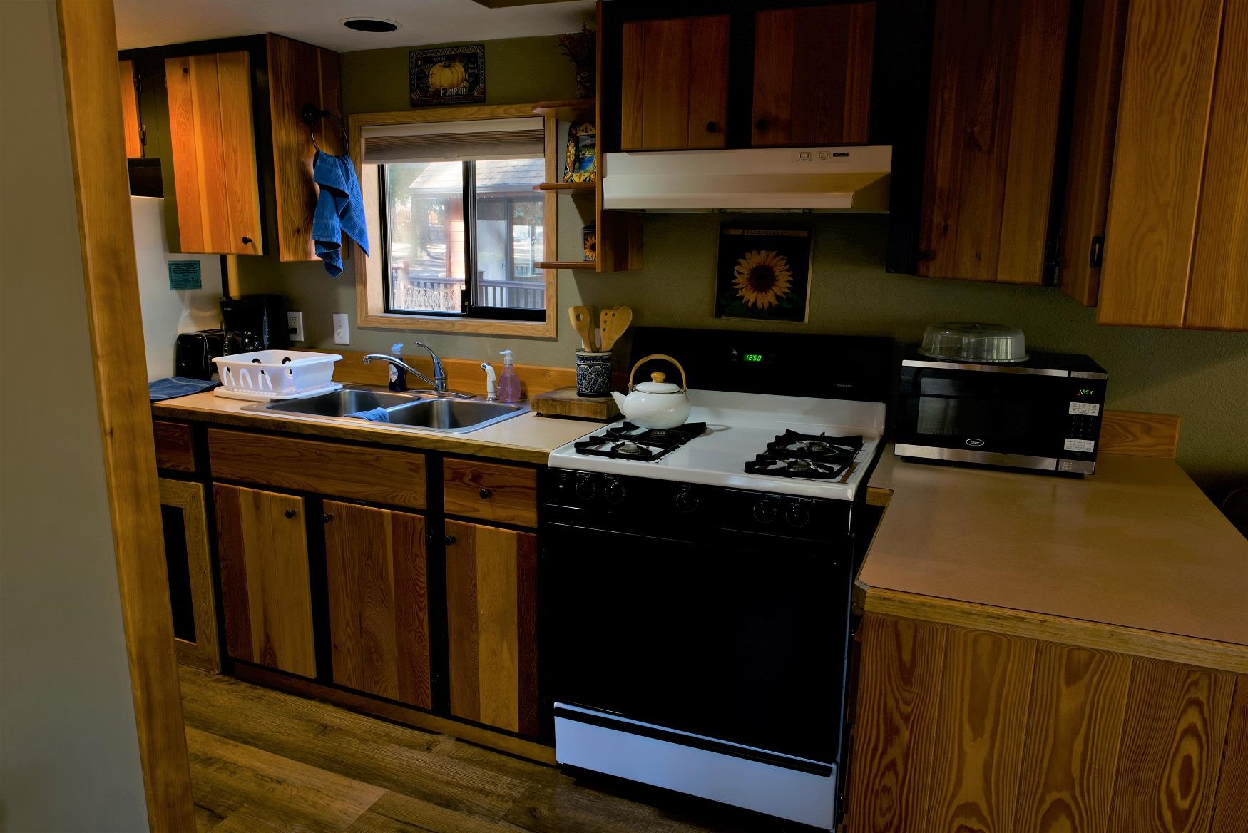 Cook up a delicious family dinner in the kitchen of Cedar Cabin at Cold Springs Resort & RV Park in Camp Sherman, Oregon