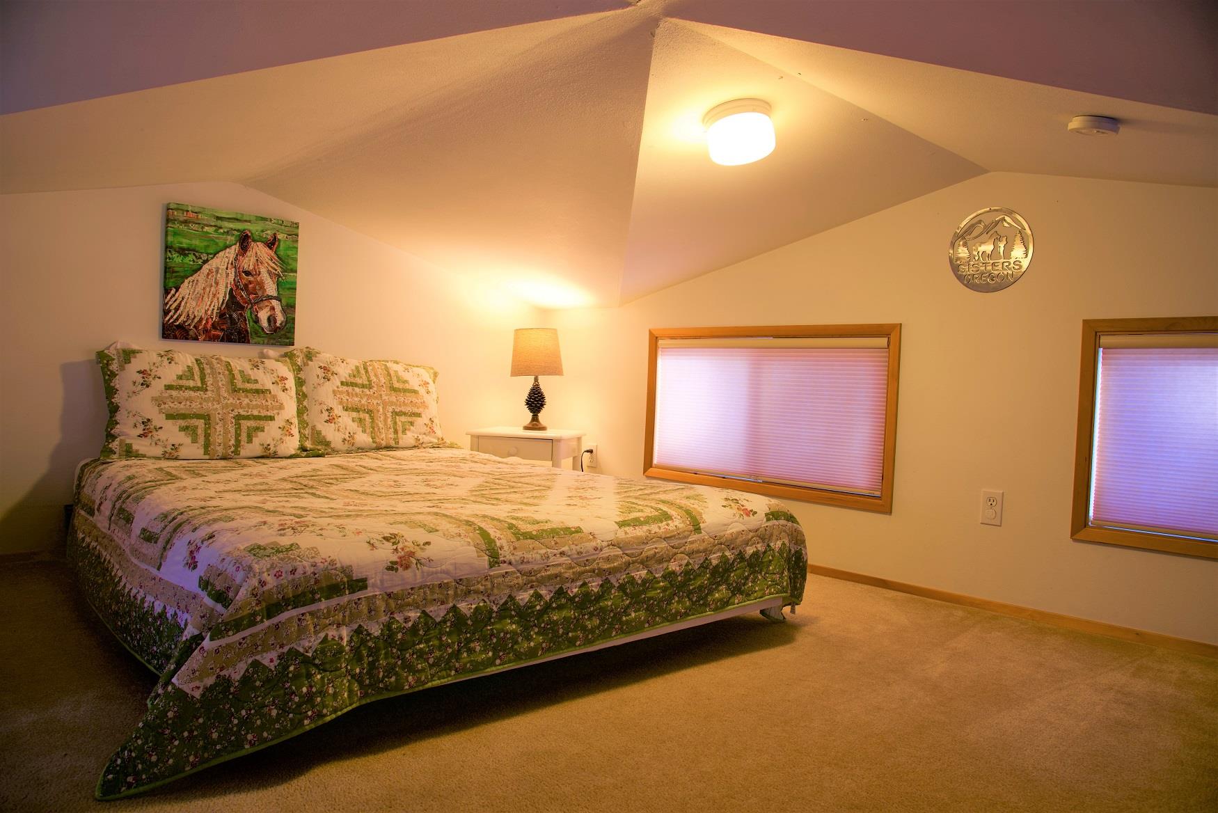 Get your best night sleep in the cozy queen bed in the loft of Maple Cabin at Cold Springs Resort & RV Park in Camp Sherman, Oregon