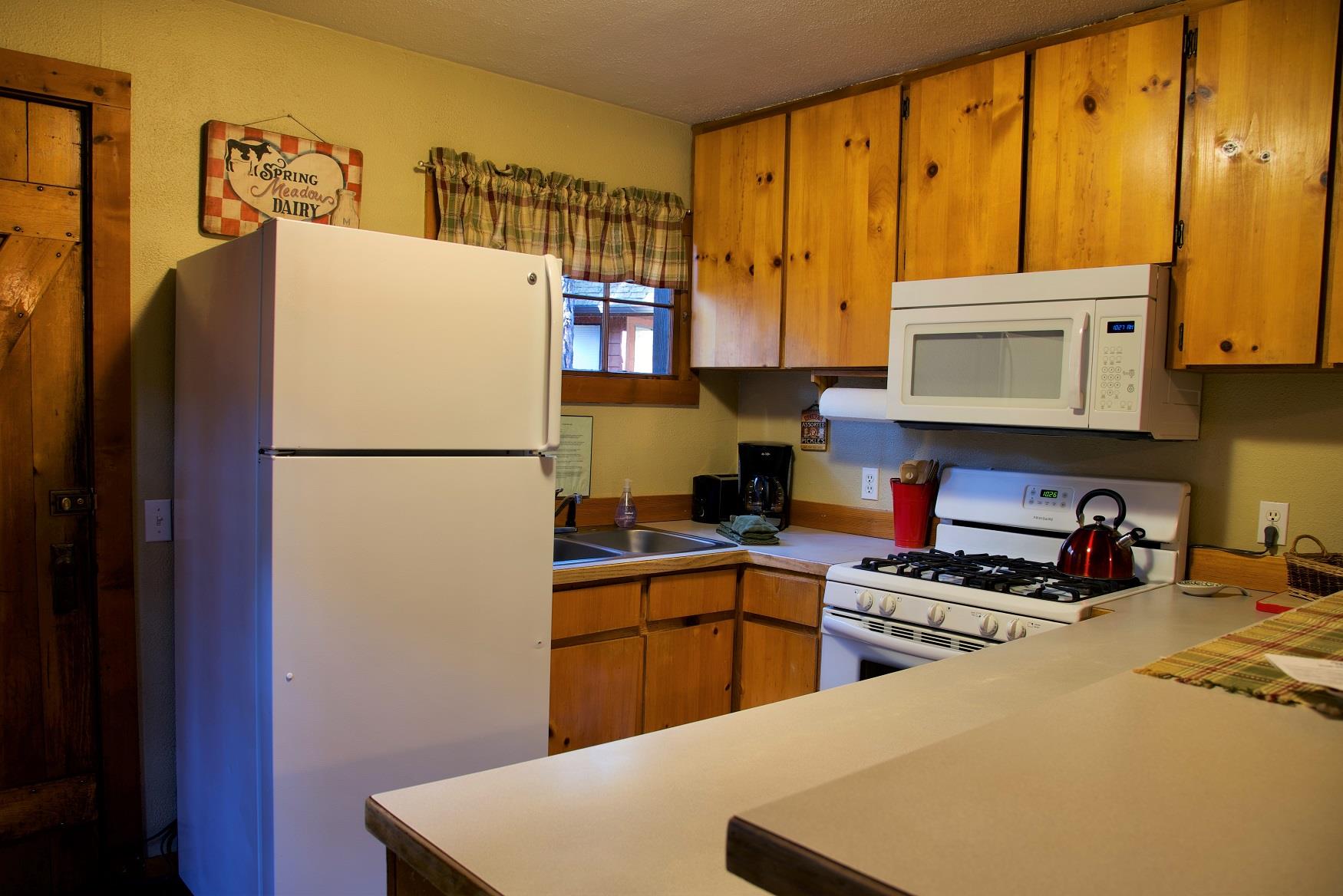 Cook up a delicious family dinner in the kitchen of Log Cabin at Cold Springs Resort & RV Park in Camp Sherman, Oregon