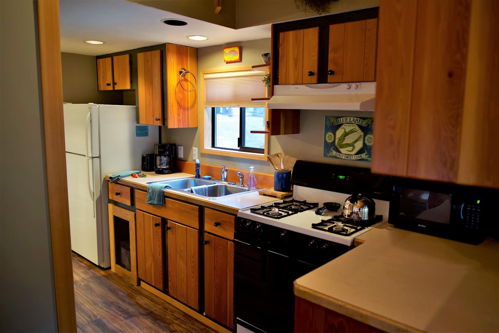 Cook up a delicious family dinner in the kitchen of Spruce Cabin at Cold Springs Resort & RV Park in Camp Sherman, Oregon