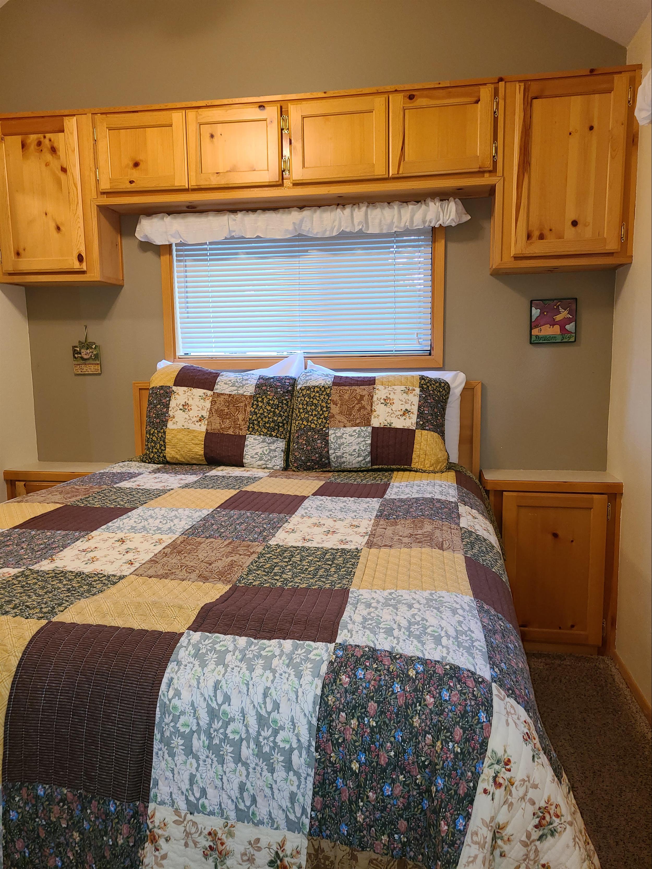The cozy bedroom of Cottonwood Cabin at Cold Springs Resort & RV Park in Camp Sherman, Oregon