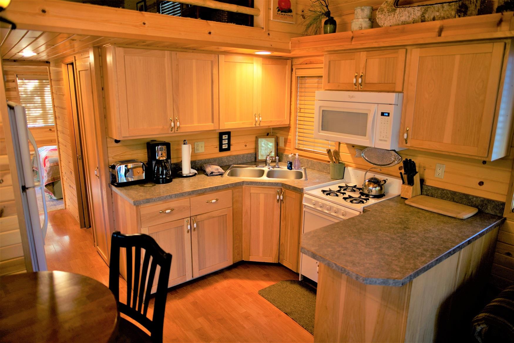 Cook up a delicious family dinner in the kitchen of Larch Cabin at Cold Springs Resort & RV Park in Camp Sherman, Oregon
