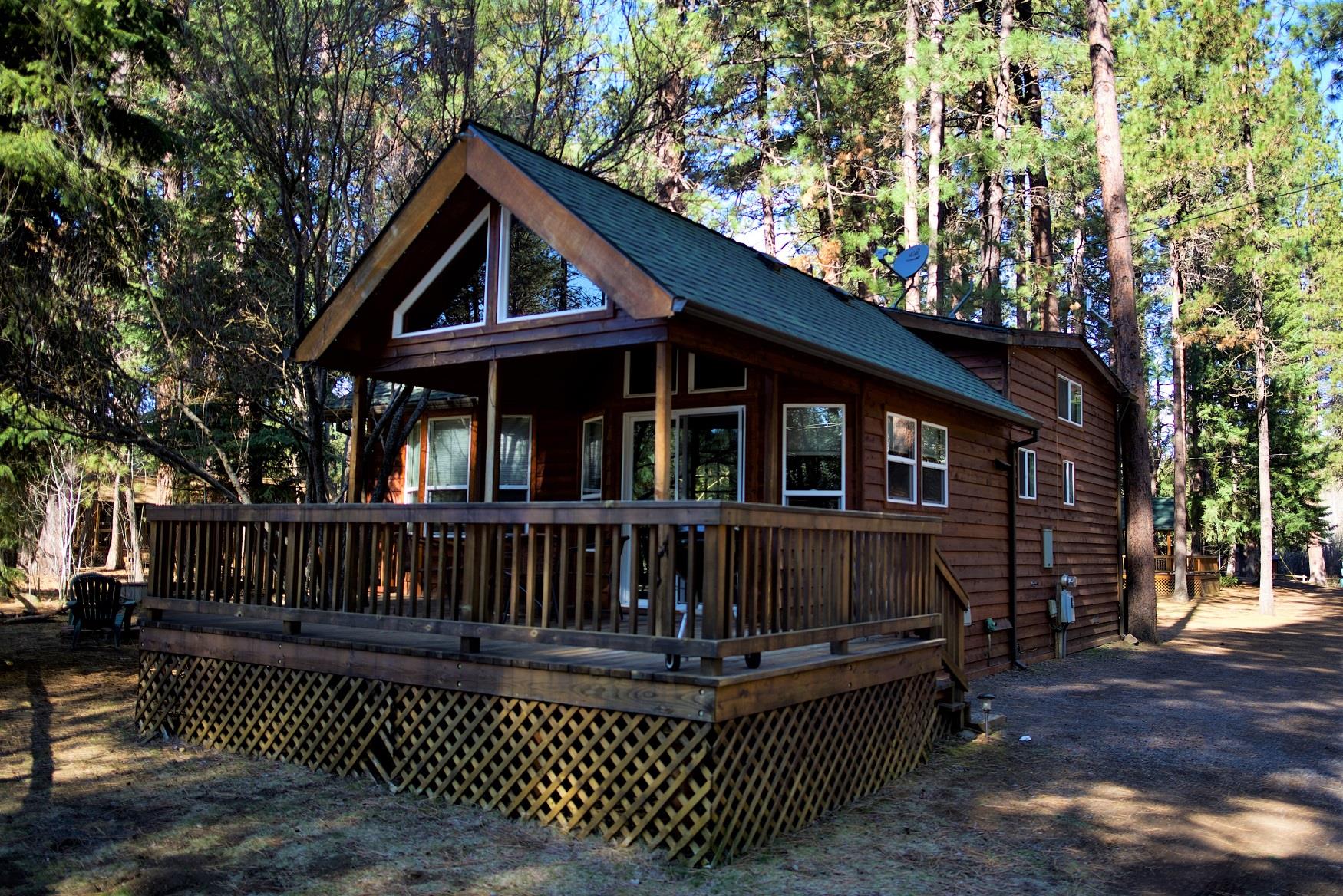 The spacious, partially covered deck on Alder Cabin, at Cold Springs Resort, has breathtaking views of the Camp Sherman wilderness. 